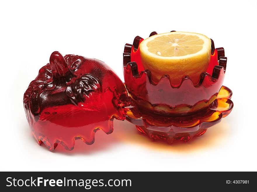 Red glass souvenir with lemon on the white background. Red glass souvenir with lemon on the white background