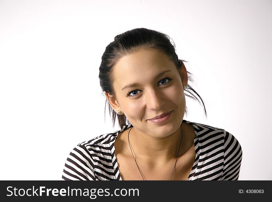 The beautiful cheerful girl on a grey background