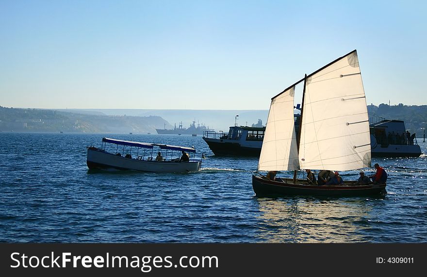 Yacht, boat and jolly boat in a bay of the black sea. Yacht, boat and jolly boat in a bay of the black sea