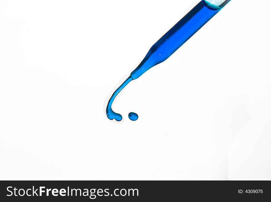 Blue water squirting from eyedropper