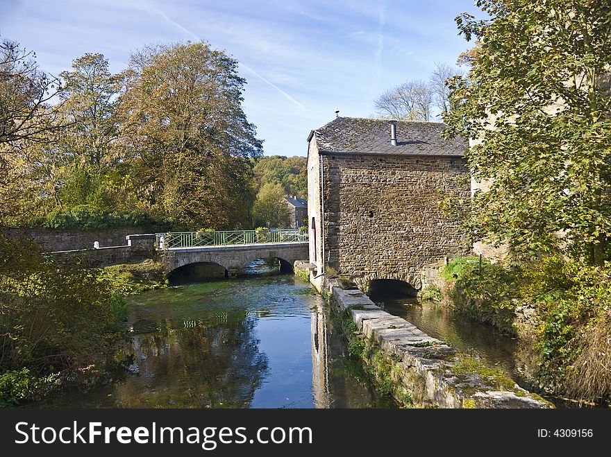 Autumn. House on a bridge.