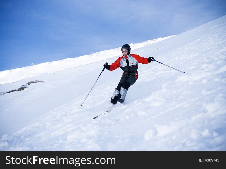 The girl on skis on a background of the blue sky