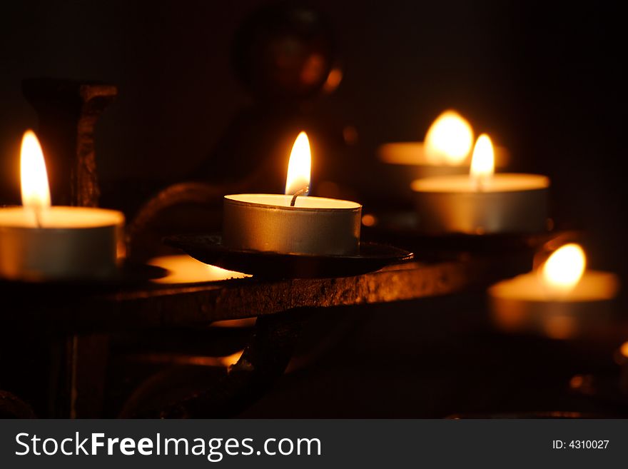 Small candles in rows in a church