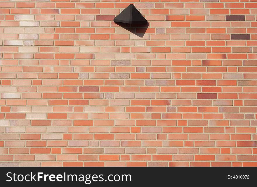 Red brick wall with a reflector