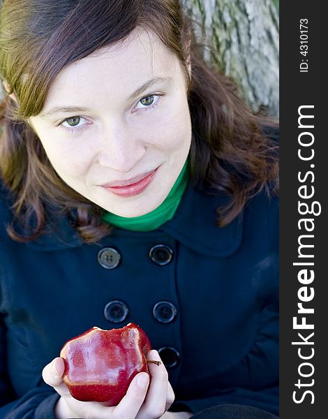 Green eyed young girl with apple in winter fashion. Green eyed young girl with apple in winter fashion