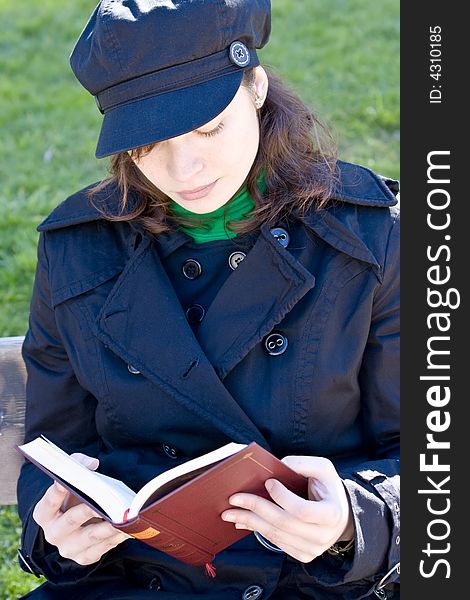 Young woman enjoying a book in the park. Young woman enjoying a book in the park