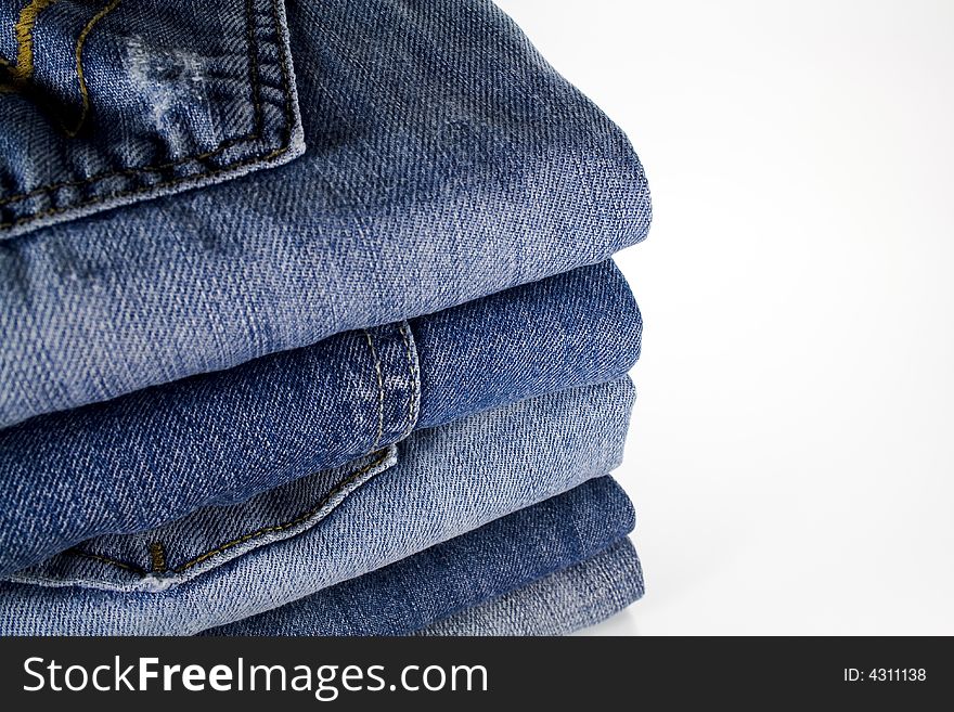 Stack of jeans over white