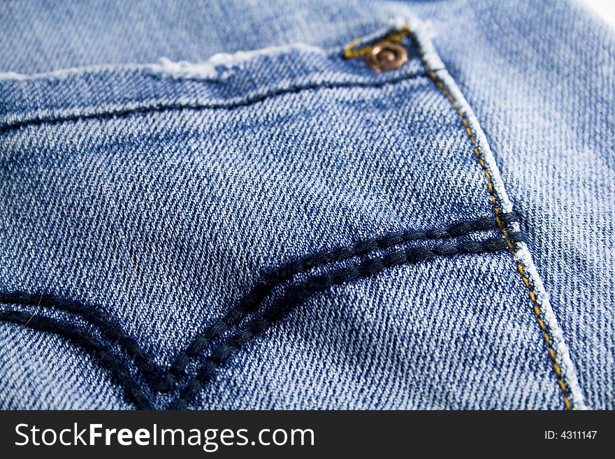 Pocket of blue jeans close up