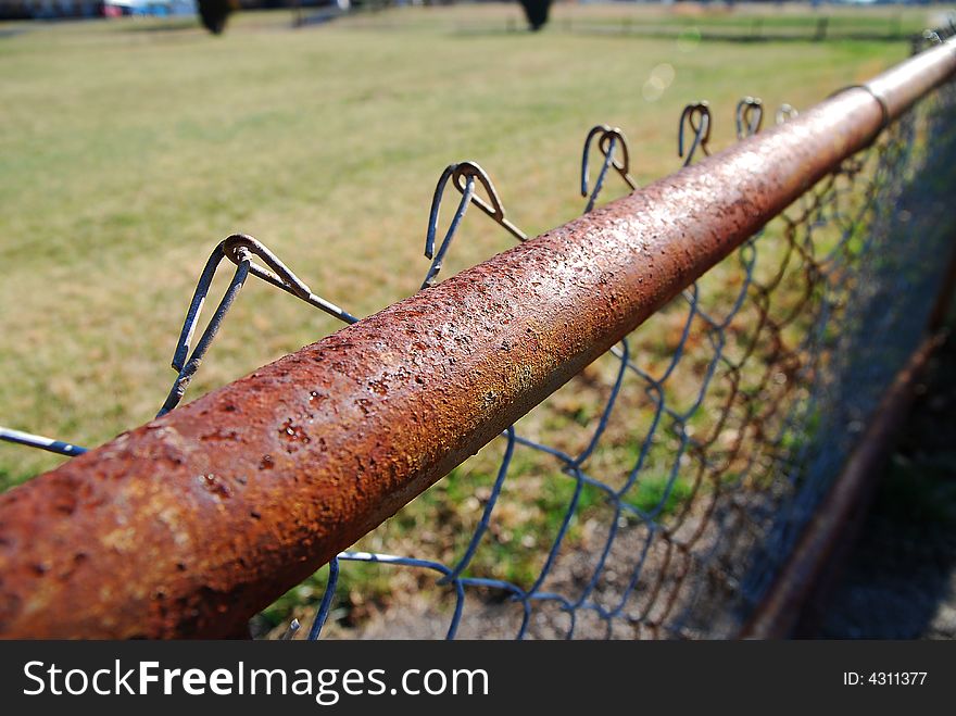 Close up of a chained link fence rail. Close up of a chained link fence rail.