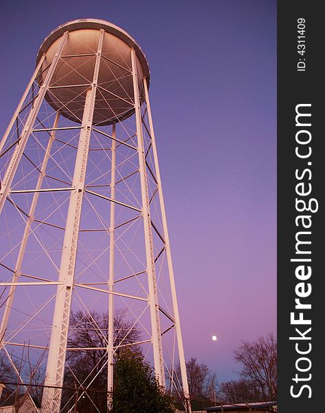 Water tower at sunset shot from below with wide angle.