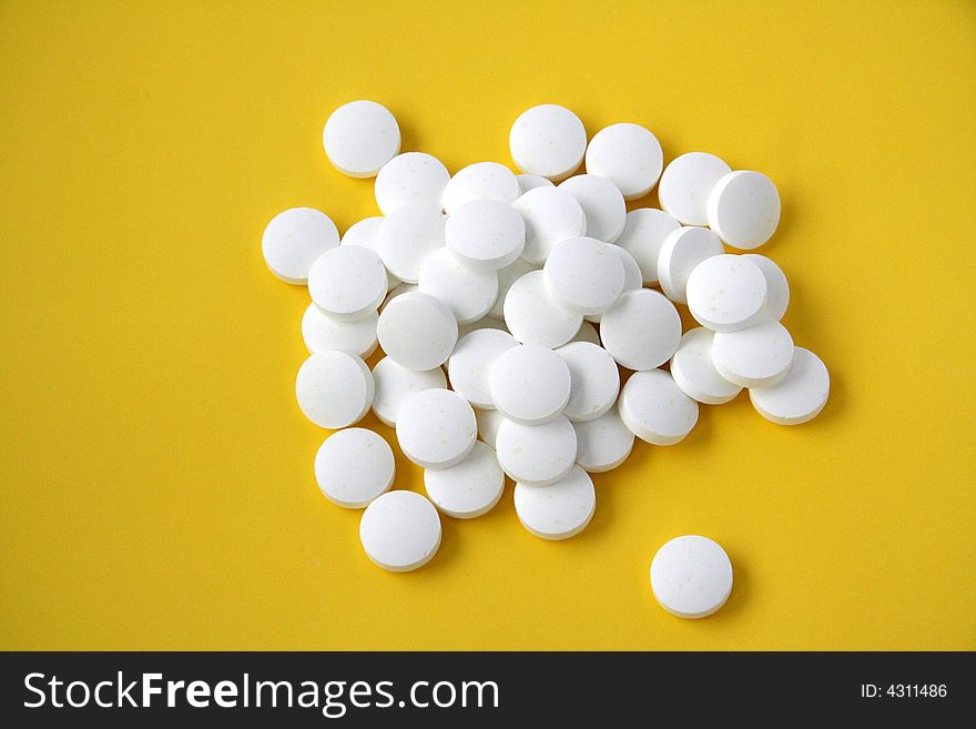 Pills isolated on yellow background. Pills isolated on yellow background.