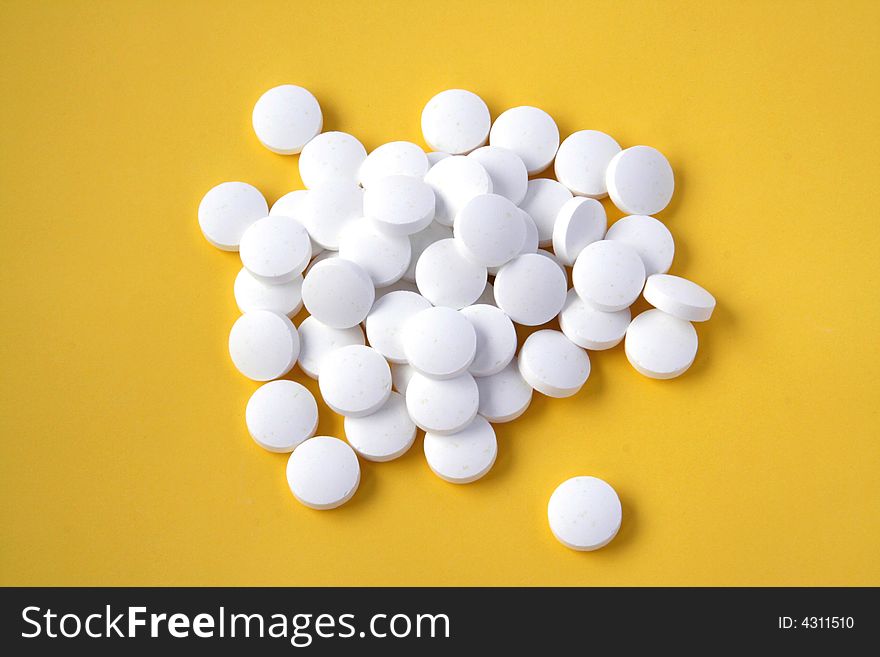 Pills isolated on yellow background. Pills isolated on yellow background.