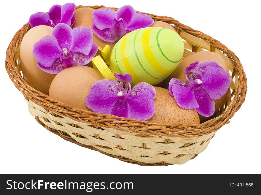 A basket of  easter eggs with flowers isolated on the white background. A basket of  easter eggs with flowers isolated on the white background