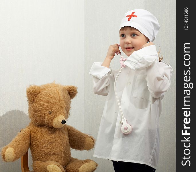 Little girl with toy-phonendoscope playing a doctor. Little girl with toy-phonendoscope playing a doctor