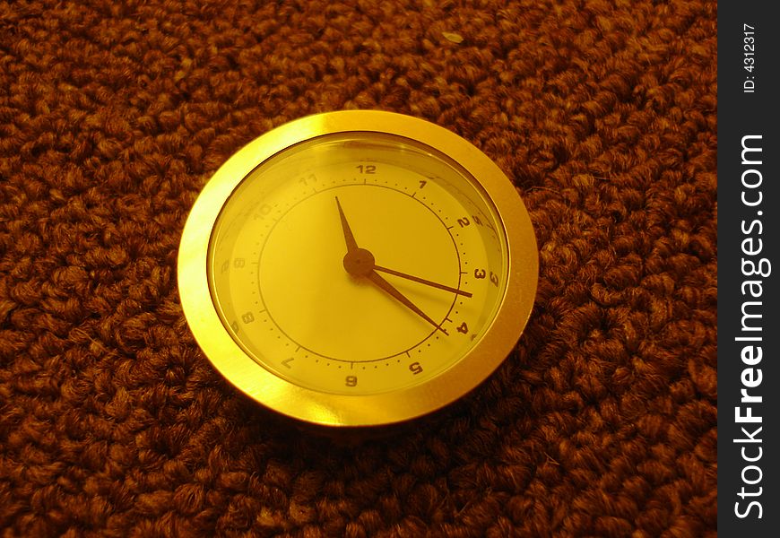 Small silver clocks lying on the carpet. Small silver clocks lying on the carpet.