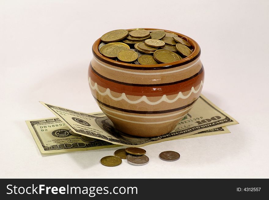 Pot with the coins, the investment of capital and obtaining profit.