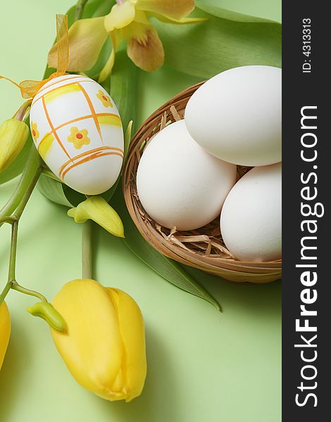 Easter egg with yellow tulip and orchid on green background. Easter egg with yellow tulip and orchid on green background.