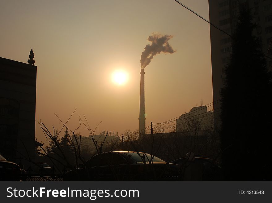 The declining sun; the setting sun chimney stack smokestack sun