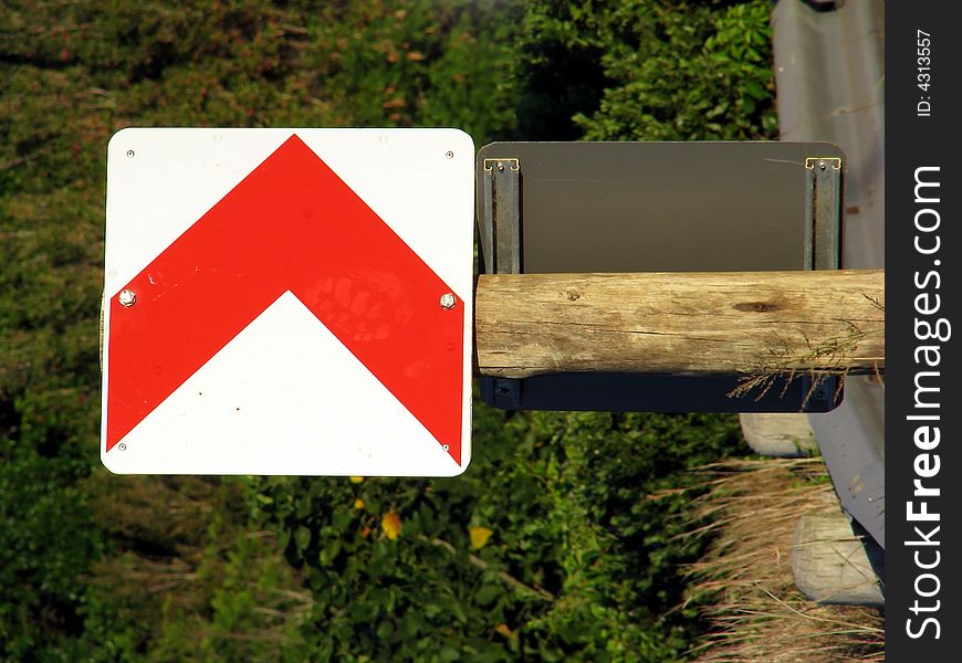 Street sign showing direction on a wooden pole