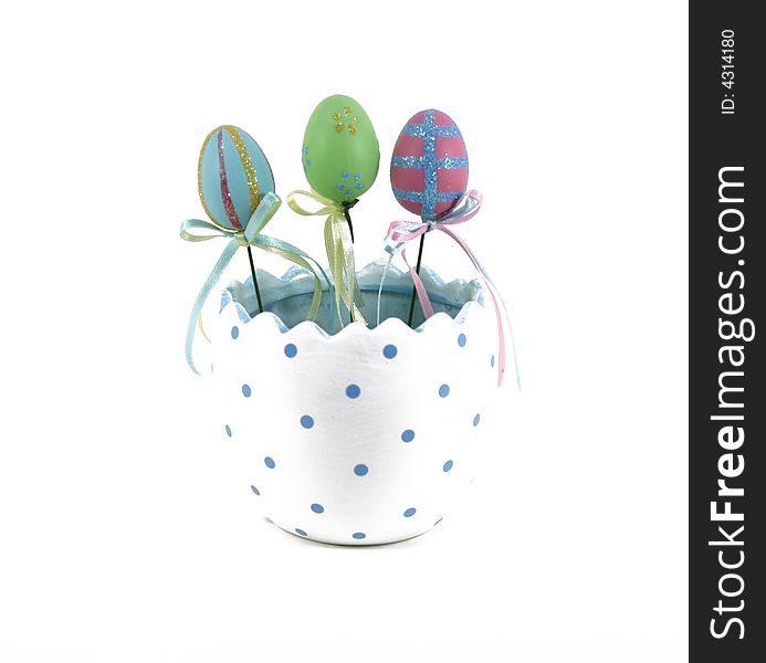 Three decorated Easter eggs in a half egg pot. Three decorated Easter eggs in a half egg pot.