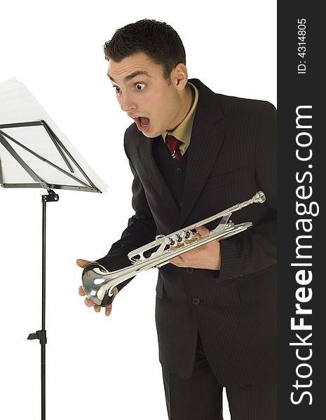 Astonished trumpeter standing in front of stillage. He's saw something on sheet music. White background. Astonished trumpeter standing in front of stillage. He's saw something on sheet music. White background.