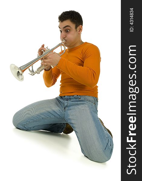 Man in orange blouse kneeling and trumpet. Low angle view. Isolated on white background. Man in orange blouse kneeling and trumpet. Low angle view. Isolated on white background.