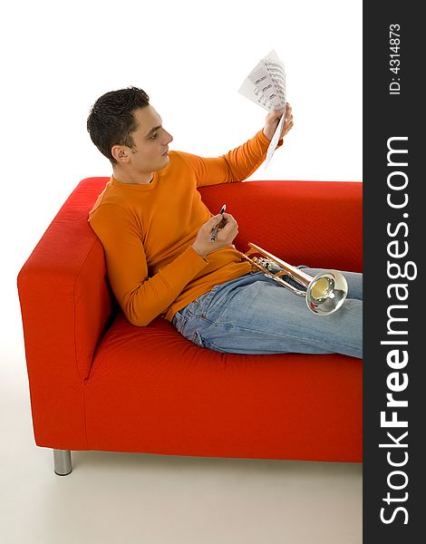 Trumpeter sitting on red couch and composing music, holding sheet music in hands.  White background. Trumpeter sitting on red couch and composing music, holding sheet music in hands.  White background.