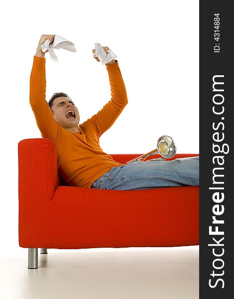 Furious trumpeter sitting on red couch and screaming with hands rising up. White background. Furious trumpeter sitting on red couch and screaming with hands rising up. White background.