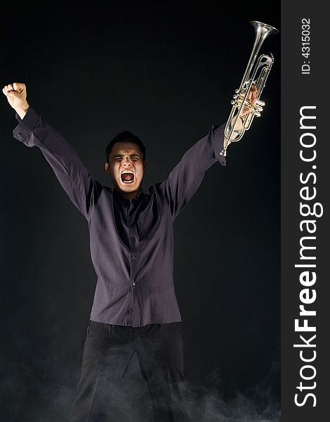 Excited man standing with trumpet in hand and screaming. Front view. Excited man standing with trumpet in hand and screaming. Front view.