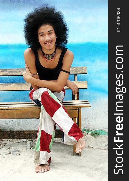 Young happy Thai man with an afro.