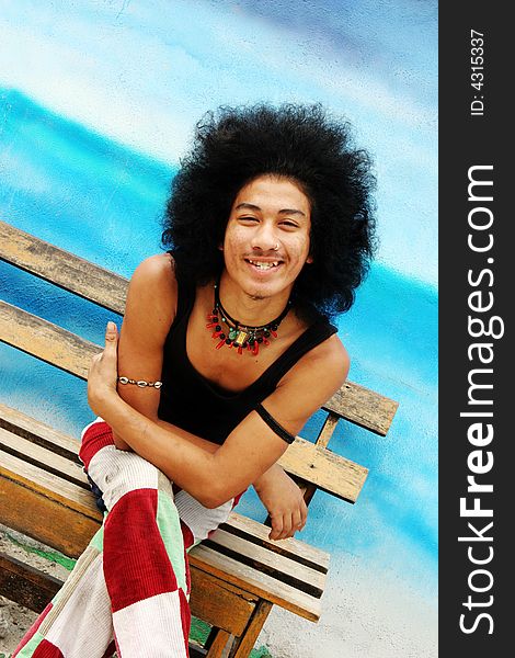 Young happy Thai man with an afro.