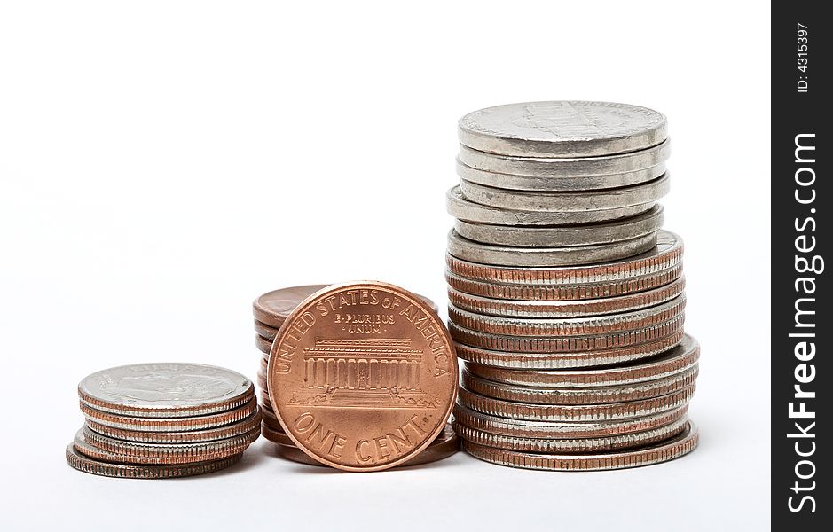 Stack of dollars and coins isolated on white