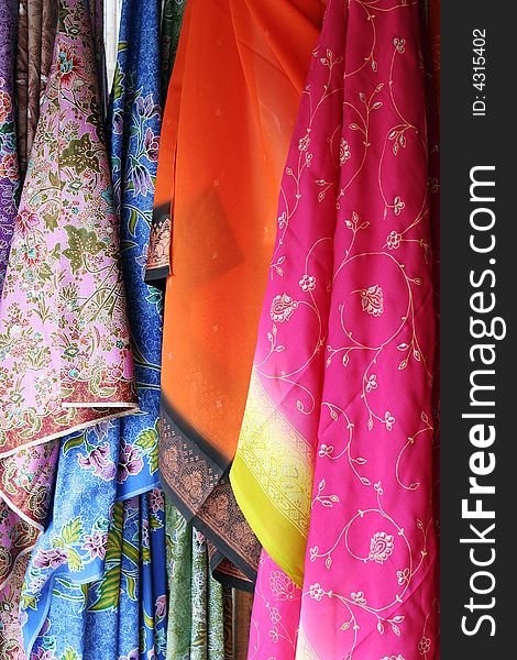 Colorful Batik saris hanging in an Asian market. Colorful Batik saris hanging in an Asian market.