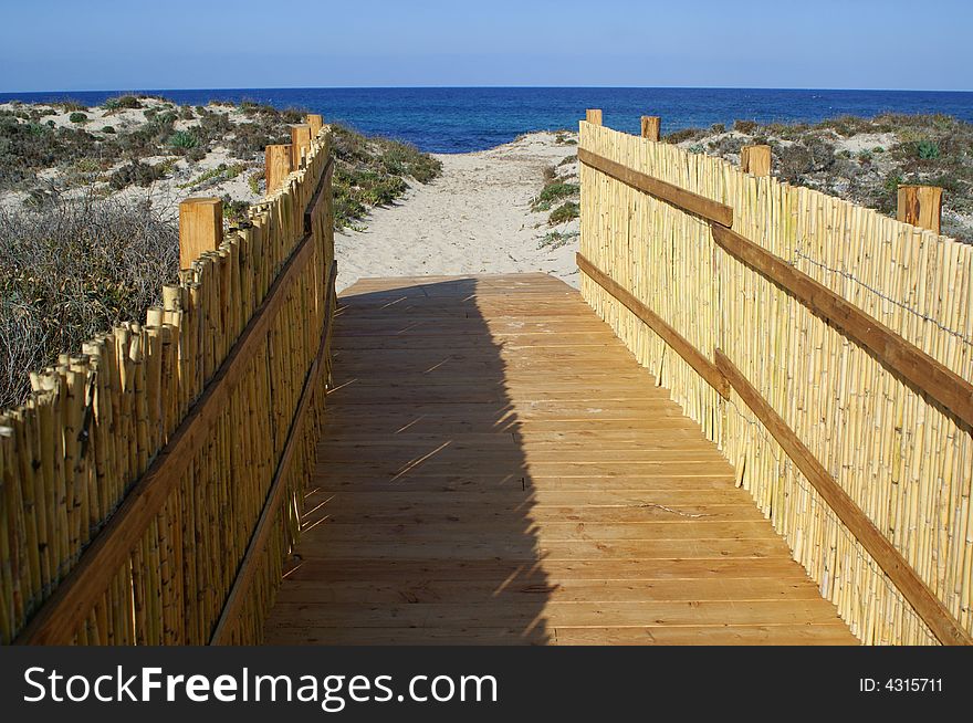 A pathway leads to a beautiful beach. Sardinia beach. A pathway leads to a beautiful beach. Sardinia beach.