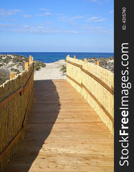 A pathway leads to a beautiful beach. Sardinia beach. A pathway leads to a beautiful beach. Sardinia beach.