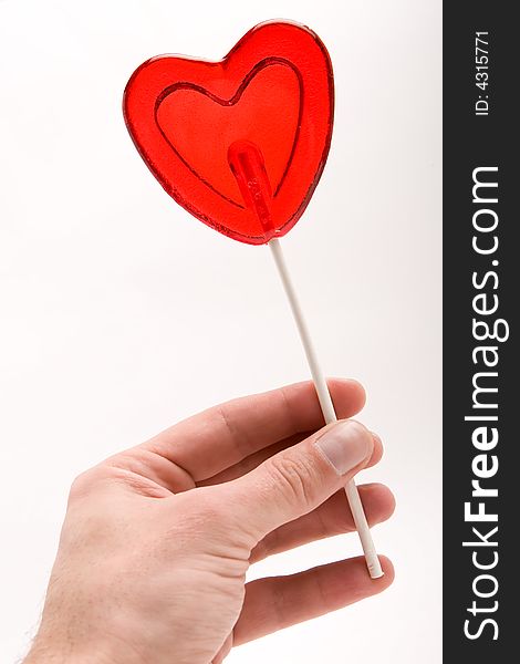 Love - Heart shape lollipop in a man's hand