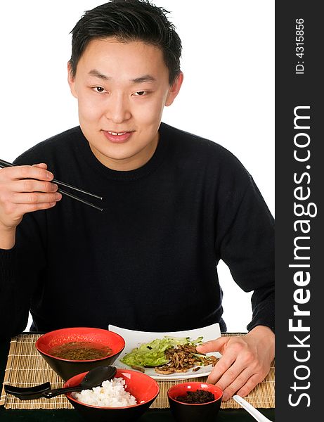 Young men eats asian food, isolated on a white background. Young men eats asian food, isolated on a white background.