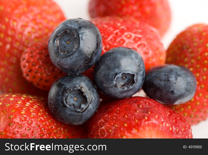 Background from fresh Strawberries and blueberry berry. Background from fresh Strawberries and blueberry berry