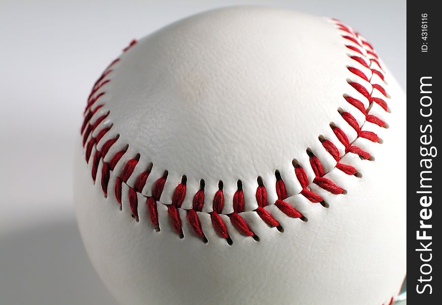 Close up of a baseball with stark white leather and bright red stitches! It looks like you're in the zone. Close up of a baseball with stark white leather and bright red stitches! It looks like you're in the zone.