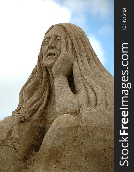 Sand sculpture of a sad woman. Sand sculpture of a sad woman