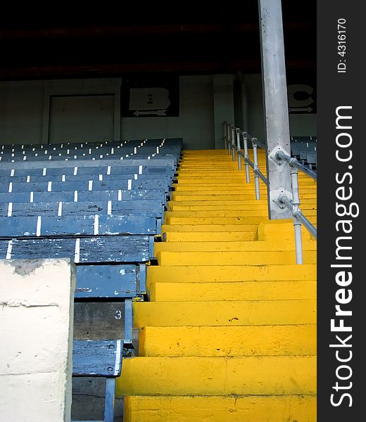 Vertical shot of a yellow staircase ascending into the grand stands at the state fairgrounds.