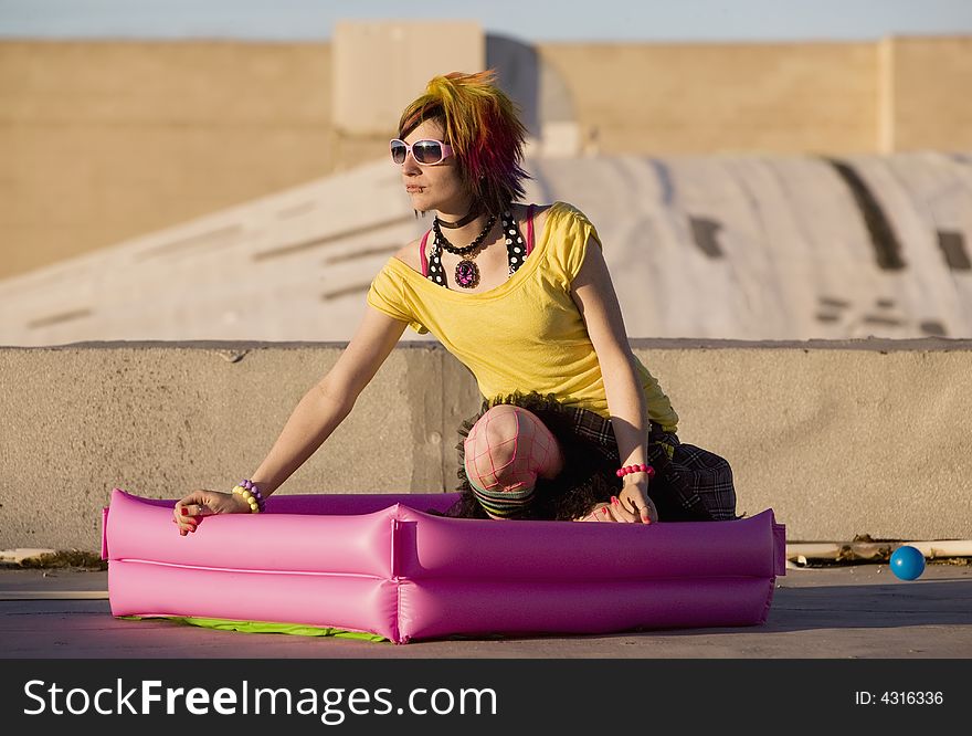 Portrait of a Punk Girl with Bright Colorful and Big Sunglasses Outdoors at Sundown. Portrait of a Punk Girl with Bright Colorful and Big Sunglasses Outdoors at Sundown