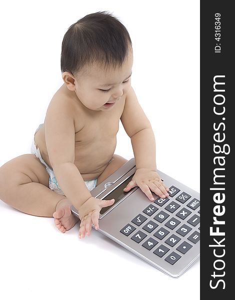 9-month delightful baby with a big pocket calculator  over a white background. 9-month delightful baby with a big pocket calculator  over a white background