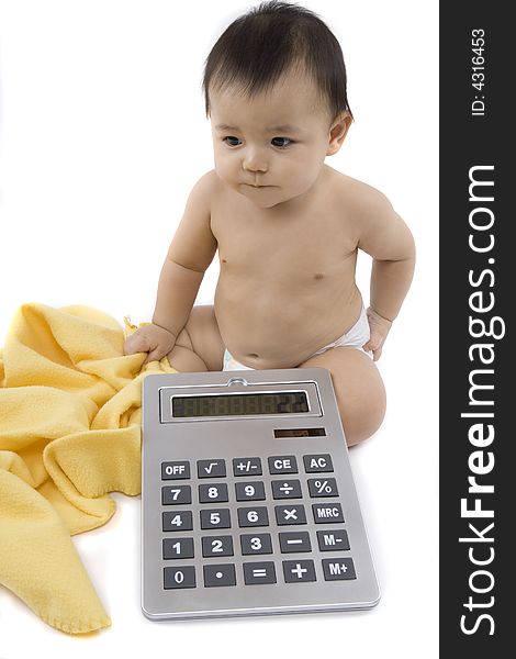 9-month delightful baby with a big pocket calculator  over a white background. 9-month delightful baby with a big pocket calculator  over a white background