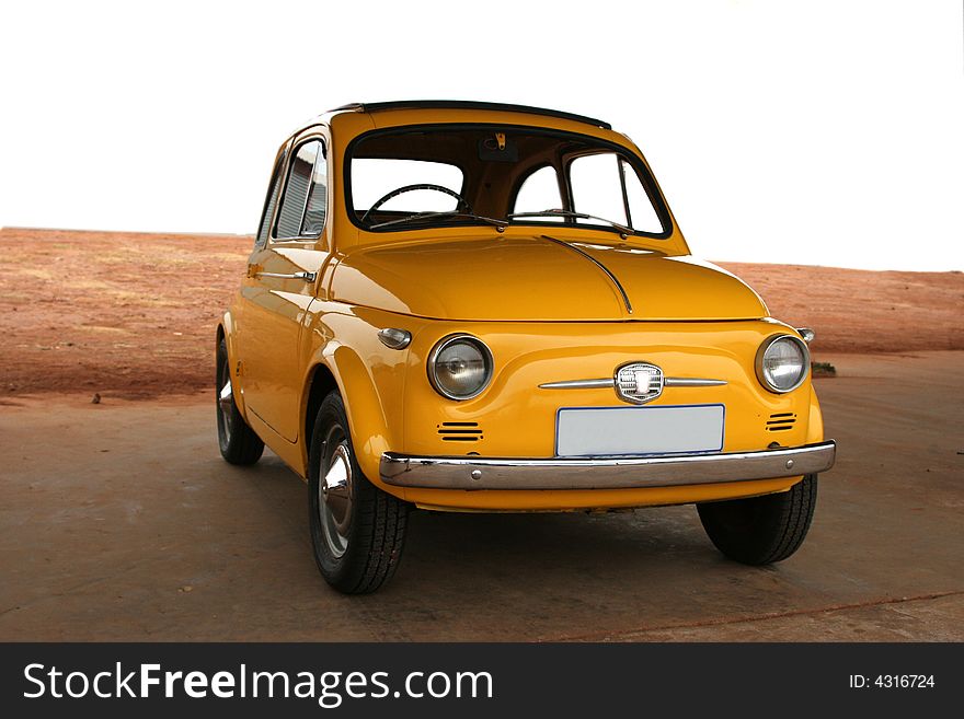 Vintage yellow car. Small funny old motorcar.