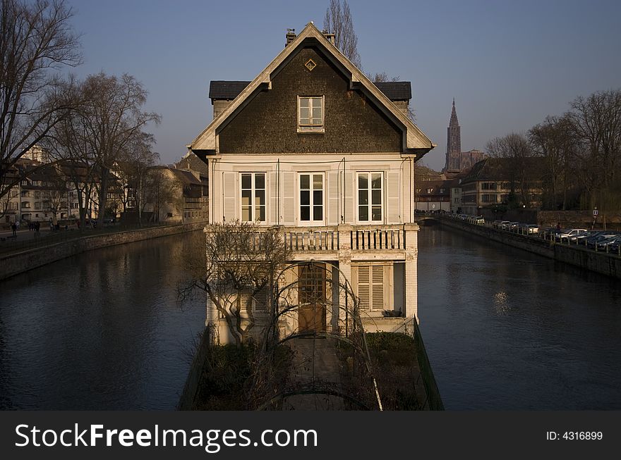 Warm sun setting light on house surrounded by canals, Strasbourg, France. Warm sun setting light on house surrounded by canals, Strasbourg, France.