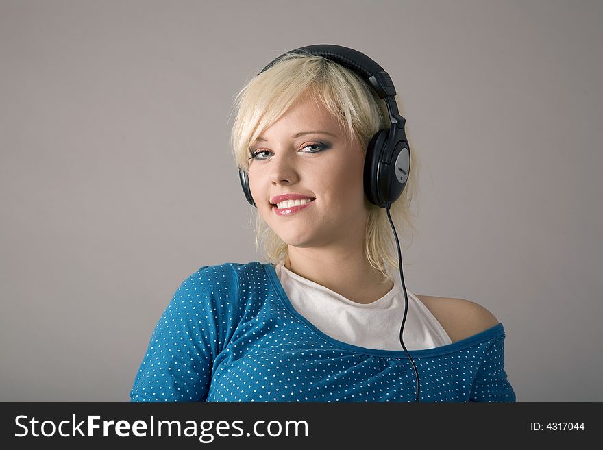 Caucasian woman listening to headphones. Caucasian woman listening to headphones