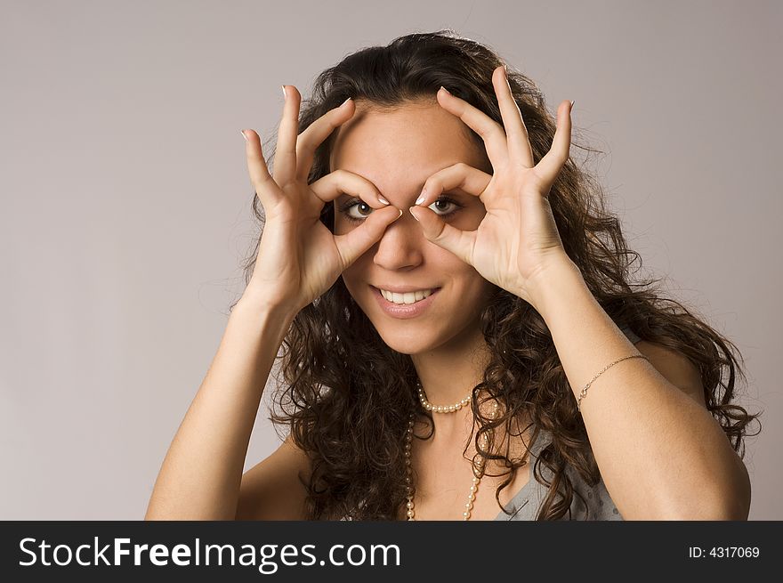 girl doing glasses from fingers portrait. girl doing glasses from fingers portrait