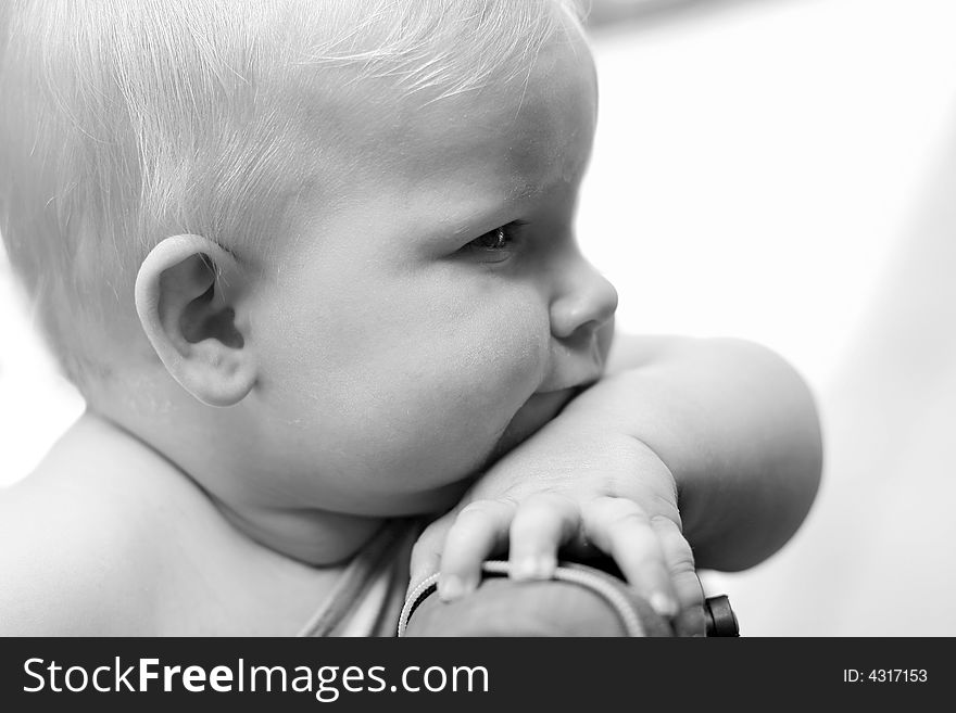 profile of thoughtful baby sitting in pram