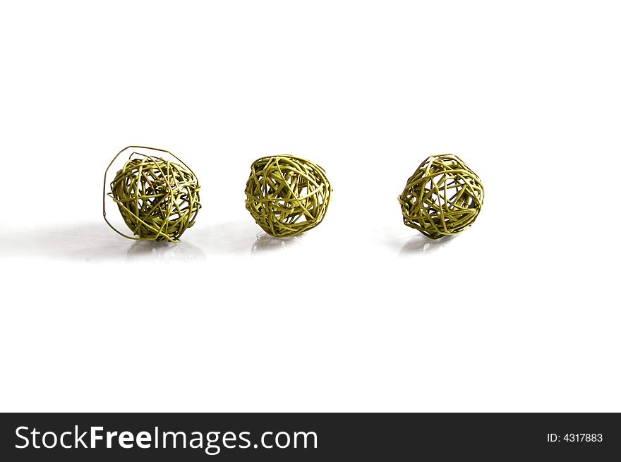 Three green balls of twine on whte background